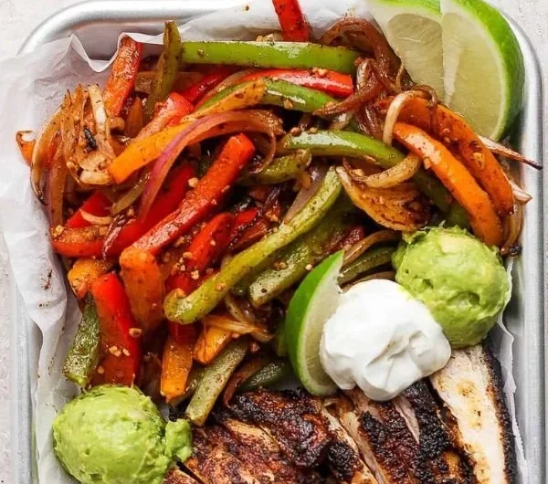 Sizzling Blackstone chicken fajitas with colorful bell peppers and onions