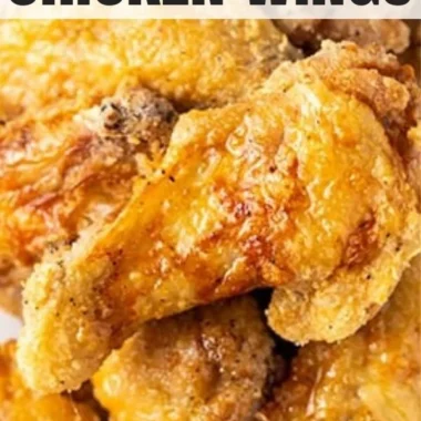 Crispy air fryer chicken wings served with dipping sauce and garnished with herbs