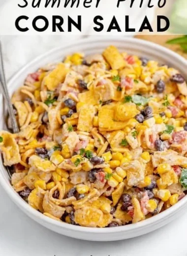 Bowl of colorful Frito Corn Salad with ingredients like corn, cheese, and Fritos.