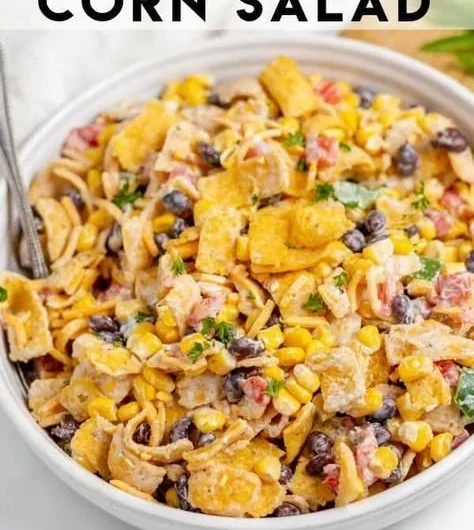 Bowl of colorful Frito Corn Salad with ingredients like corn, cheese, and Fritos.