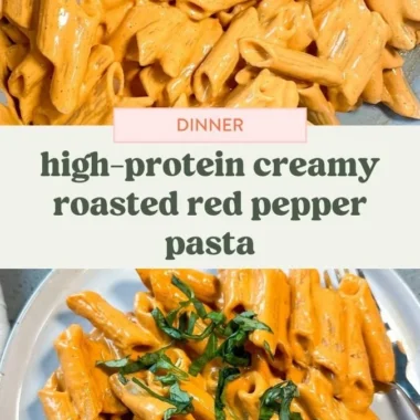 Bowl of high protein creamy roasted red pepper pasta topped with fresh herbs.