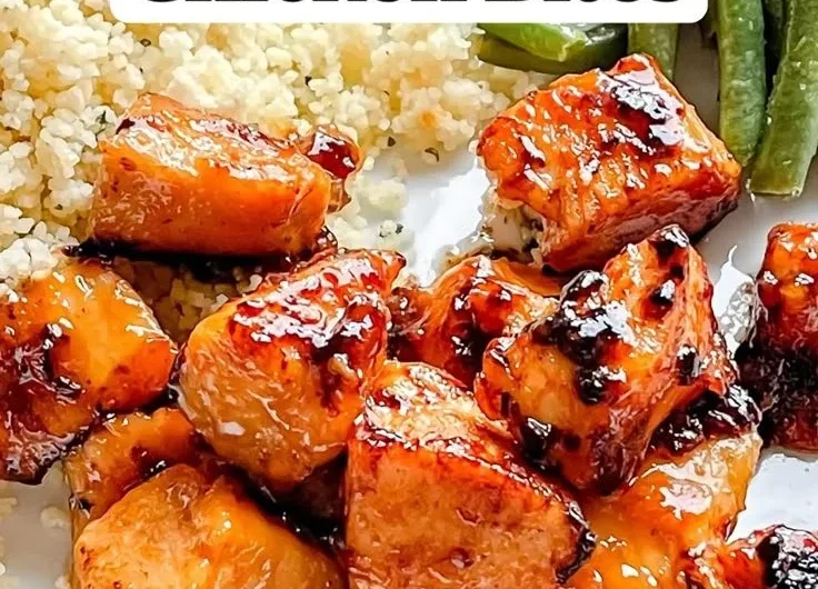 Delicious Honey Garlic Chicken Bites on a platter, garnished with green onions.