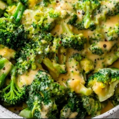 Delicious plate of cheesy broccoli topped with melted cheese