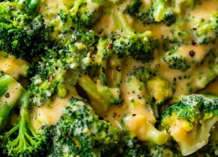 Delicious plate of cheesy broccoli topped with melted cheese