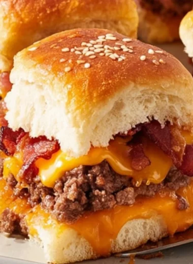 Delicious Bacon Cheeseburger Slider Bake topped with melted cheese and bacon