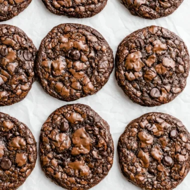 Baked brownie mix cookies with chocolate chunks on a cooling rack.