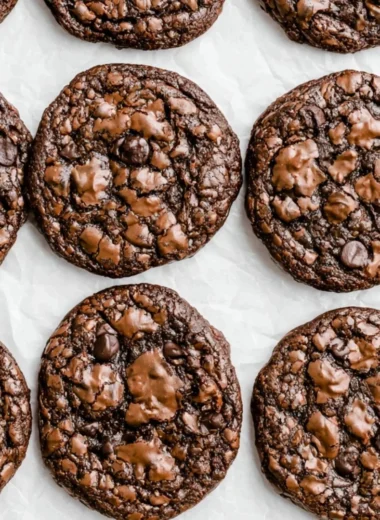 Baked brownie mix cookies with chocolate chunks on a cooling rack.