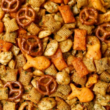 Bowl of Cheesy Ranch Chex Mix with a vibrant mix of snacks