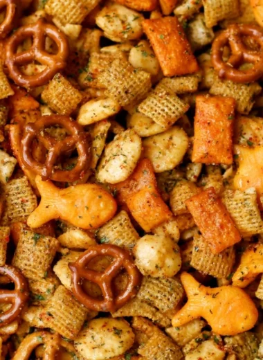 Bowl of Cheesy Ranch Chex Mix with a vibrant mix of snacks