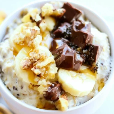 Bowl of Chunky Monkey Overnight Oats topped with bananas and chocolate chips