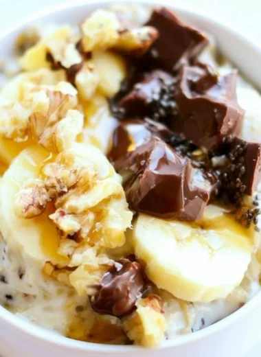 Bowl of Chunky Monkey Overnight Oats topped with bananas and chocolate chips