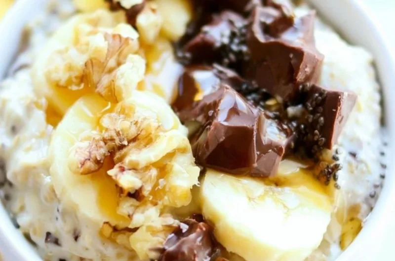 Bowl of Chunky Monkey Overnight Oats topped with bananas and chocolate chips