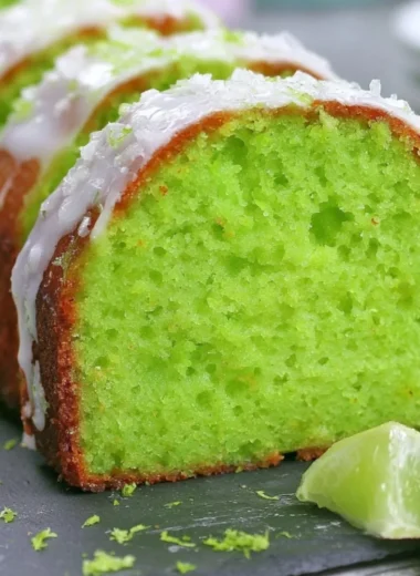 Cozy Key Lime Poke Cake topped with whipped cream and lime slices