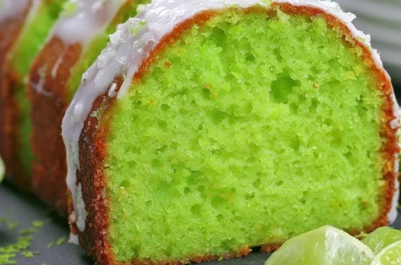 Cozy Key Lime Poke Cake topped with whipped cream and lime slices