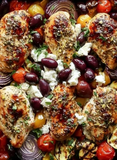 Cozy sheet pan Greek chicken with mixed veggies ready to serve.
