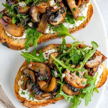 Delicious creamy mushroom toast topped with herbs and cheese