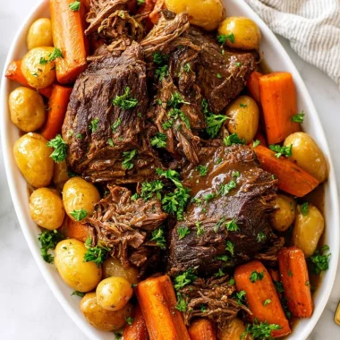 Delicious crock pot pot roast with vegetables and herbs in a slow cooker.