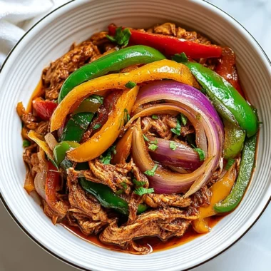 Delicious Crockpot Fajitas with chicken and peppers in a slow cooker.