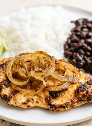 Delicious Cuban Grilled Chicken on a plate with herbs and tropical sides