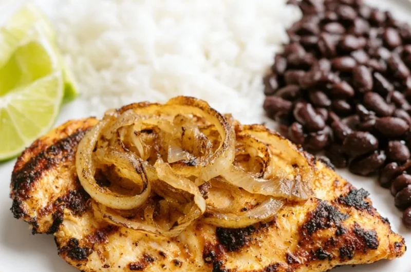 Delicious Cuban Grilled Chicken on a plate with herbs and tropical sides