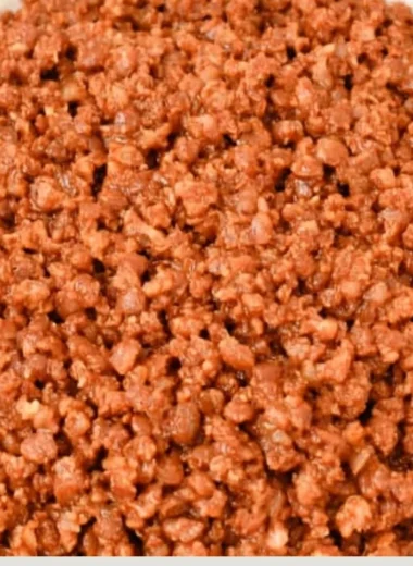 Bowl of easy lentil taco meat with toppings served in corn tortillas