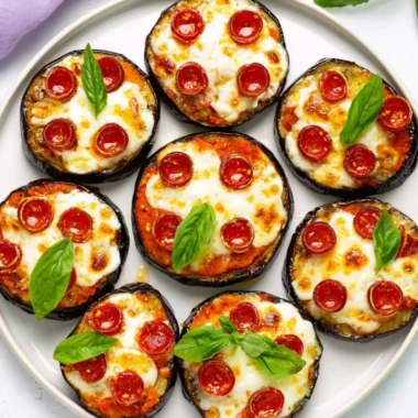 Delicious mini eggplant pizza topped with cheese and fresh herbs