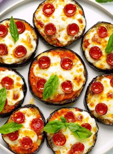 Delicious mini eggplant pizza topped with cheese and fresh herbs