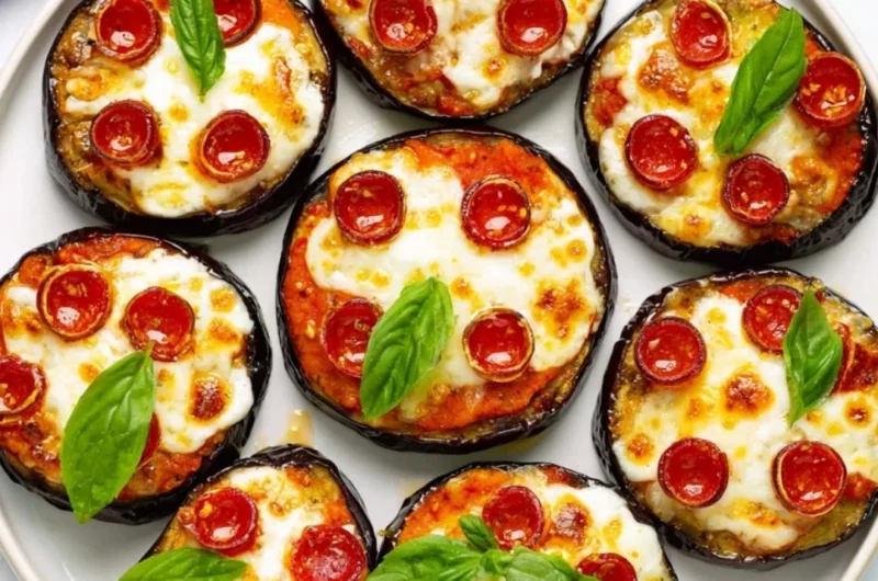Delicious mini eggplant pizza topped with cheese and fresh herbs