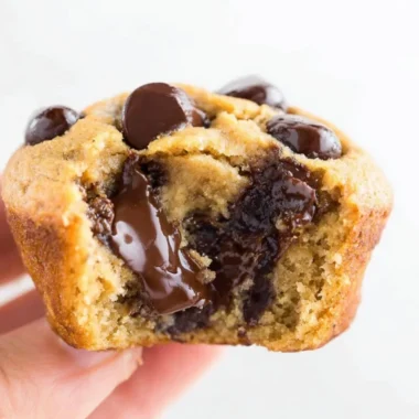Flourless peanut butter banana muffins on a wooden table.