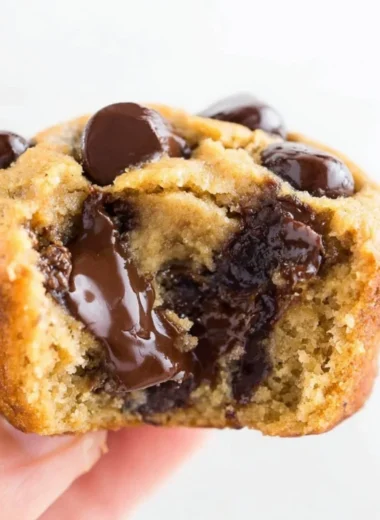 Flourless peanut butter banana muffins on a wooden table.