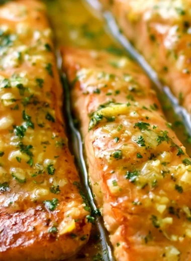 Delicious Garlic Butter Salmon fillet garnished with herbs and lemon slices
