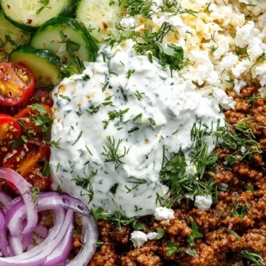 Delicious Greek Ground Beef Bowl topped with creamy Tzatziki sauce