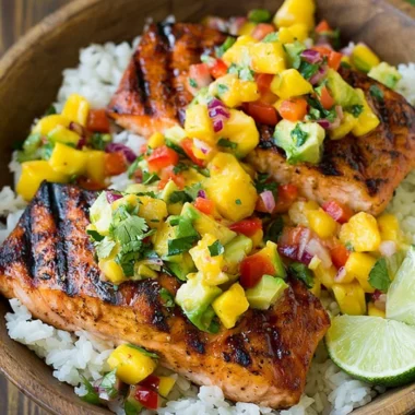 Grilled salmon fillet with mango salsa and a side of coconut rice.