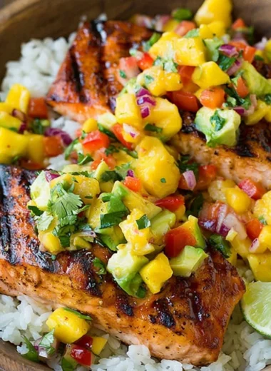 Grilled salmon fillet with mango salsa and a side of coconut rice.
