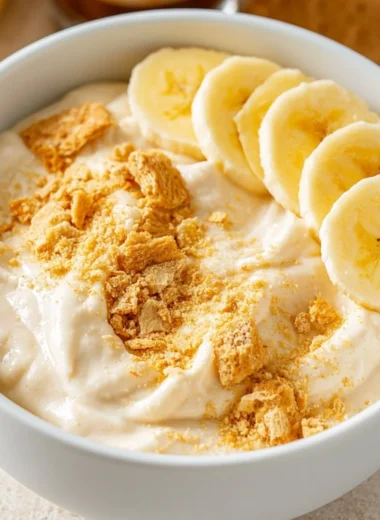 Healthy high protein banana pudding bowl topped with fresh bananas and nuts