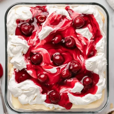 A slice of Heaven on Earth Cake with creamy layers and fruit topping