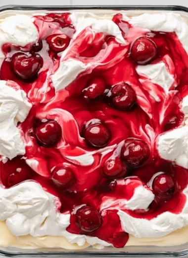 A slice of Heaven on Earth Cake with creamy layers and fruit topping
