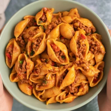 A delicious bowl of high protein taco pasta topped with fresh herbs and cheese.