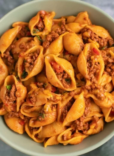 A delicious bowl of high protein taco pasta topped with fresh herbs and cheese.