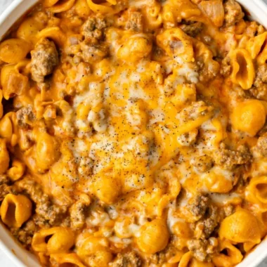 A bowl of Homemade Hamburger Helper garnished with herbs, showcasing a hearty meal.