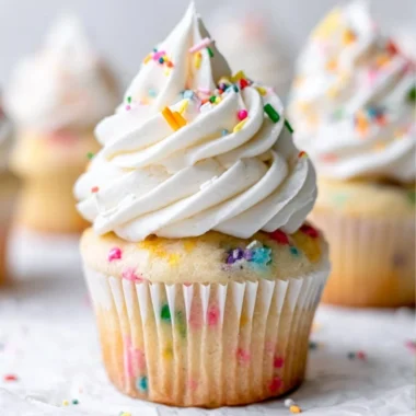 Delicious homemade vanilla cupcakes topped with creamy frosting