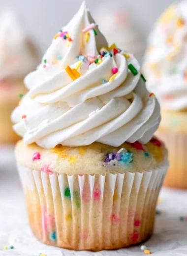 Delicious homemade vanilla cupcakes topped with creamy frosting