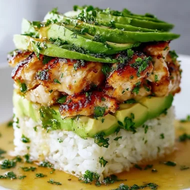 Honey Lime Chicken Avocado Rice Stack garnished with lime slices and avocado.