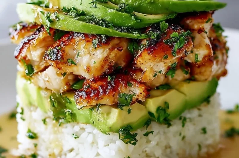Honey Lime Chicken Avocado Rice Stack garnished with lime slices and avocado.