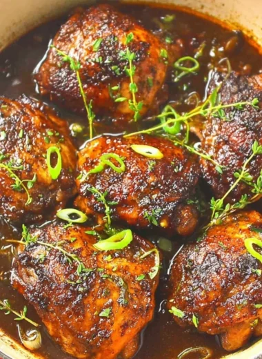 Slow cooker jerk chicken garnished with fresh herbs and spices