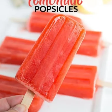 Homemade strawberry lemonade popsicles served on a sunny day