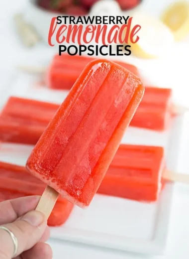 Homemade strawberry lemonade popsicles served on a sunny day