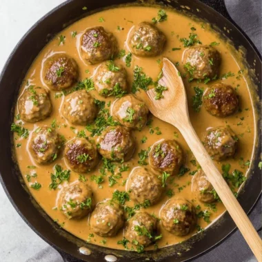 Delicious Swedish meatballs served with creamy sauce and lingonberry jam