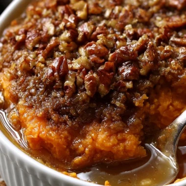 Creamy sweet potato casserole topped with marshmallows and pecans.