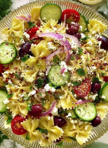 Delicious tangy Mediterranean pasta salad with colorful vegetables and dressing